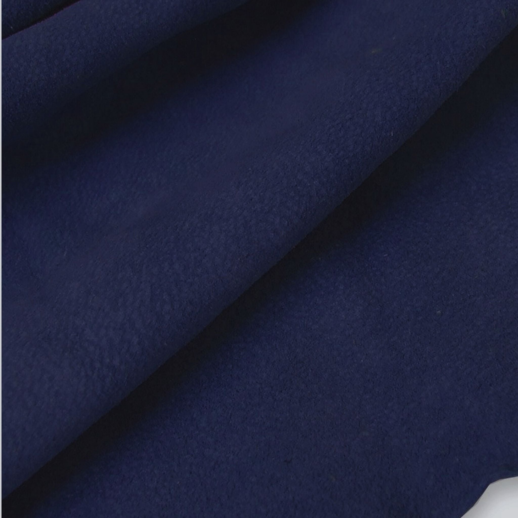 Close up Dark navy soft suede ideal for machine sewing , for making clothes, linings, cushions etc