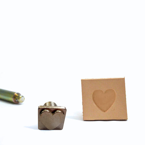 Load image into Gallery viewer, Recessed Heart mini stamp made from cast metal that leaves a sharp clear impression when stamped into dampened vegetable tanned leather. 
