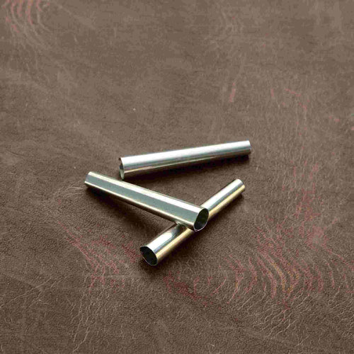 Load image into Gallery viewer, Lightweight aluminium cones used decoratively for native American regalia. The are also often used on fringing, and as lace endings. The metal is soft and can be crimped to hold in place. 
