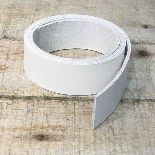 Load image into Gallery viewer, Image showing dyed veg tan leather strip in white.
