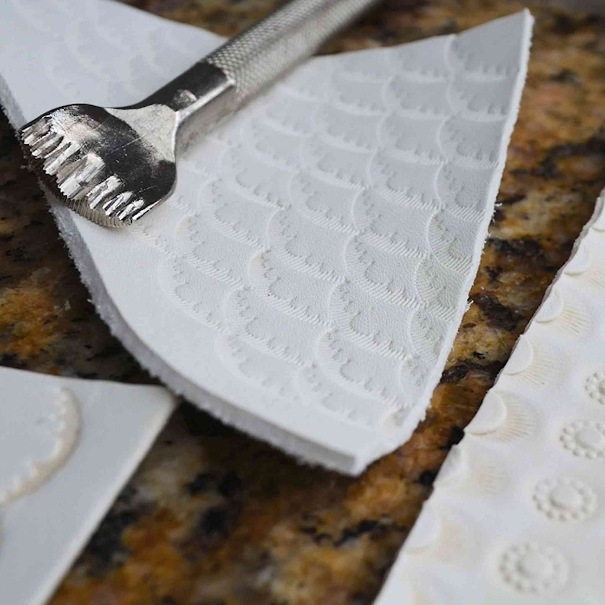 Eco creamy white leather being embossed and stamped