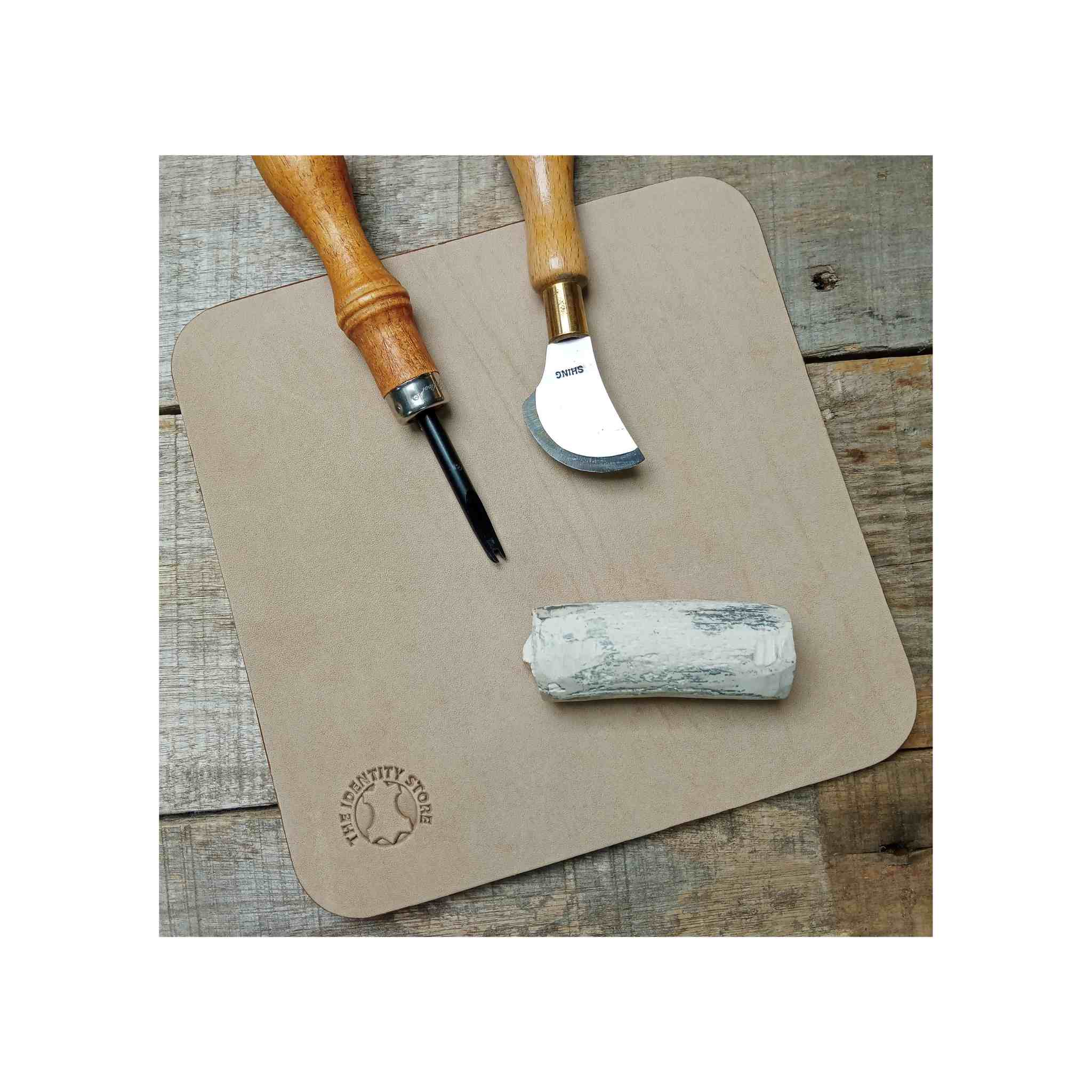 Leather stropping and cutting mat with leathercraft tools and jeweler's rouge for stropping knives and edge bevellers