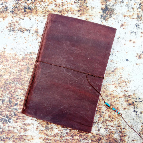 Load image into Gallery viewer, Showing a leather stitched notebook on an A3 printed rust effect photography background
