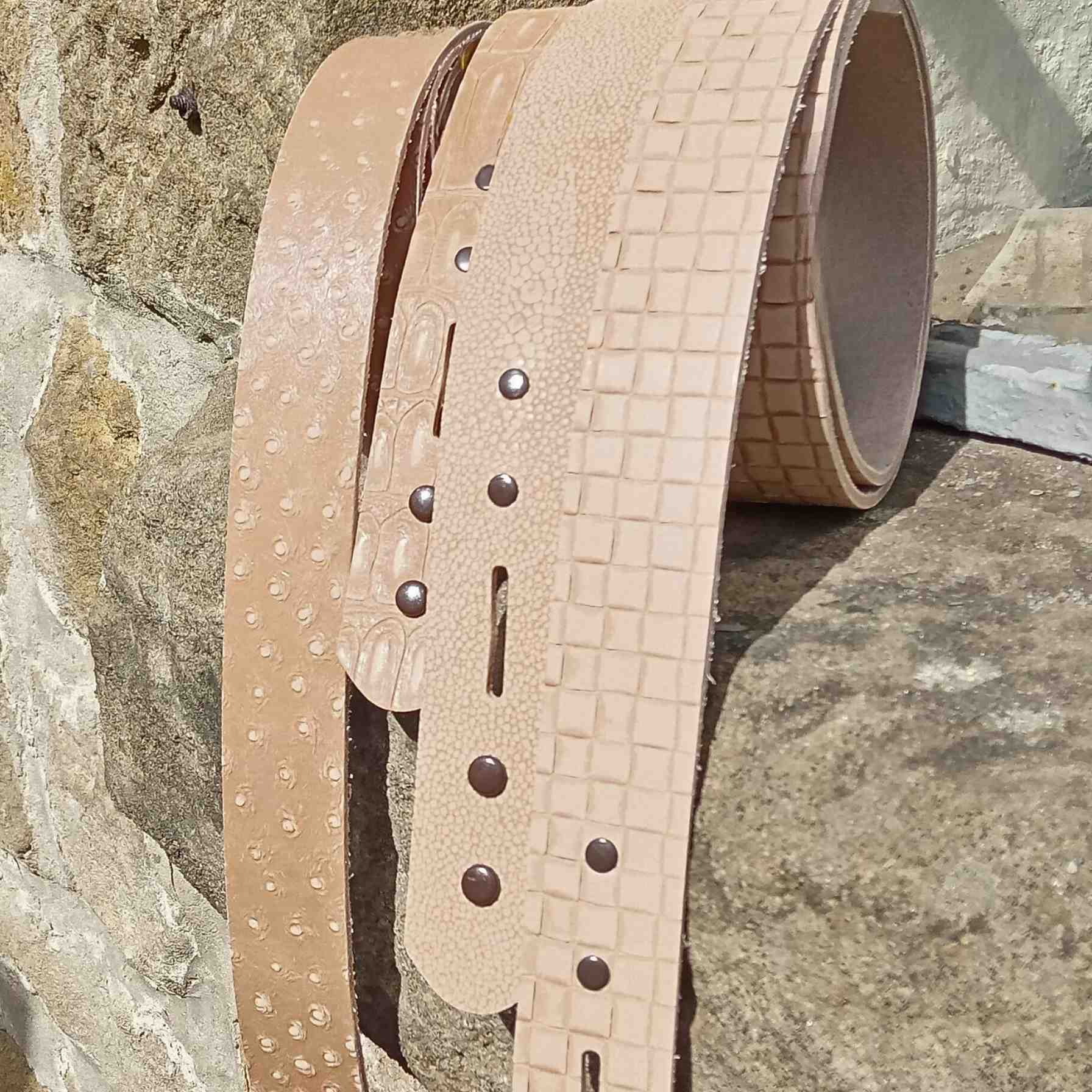 Patterned and embossed leather belt blanks ready for dyeing and colouring and adding the buckle