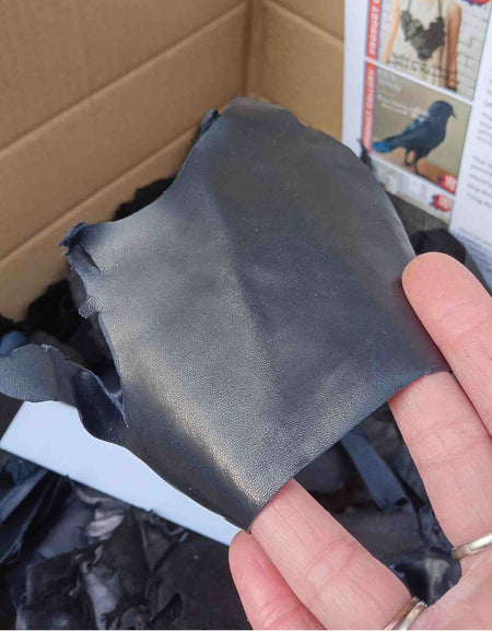 Close up to show midnight blue piece of gloving leather from the trimmings box