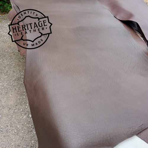 Load image into Gallery viewer, softer mellow type cowhide type leather in butts or short backs. Long lengths, a dark Bourneville Brown in colour.
