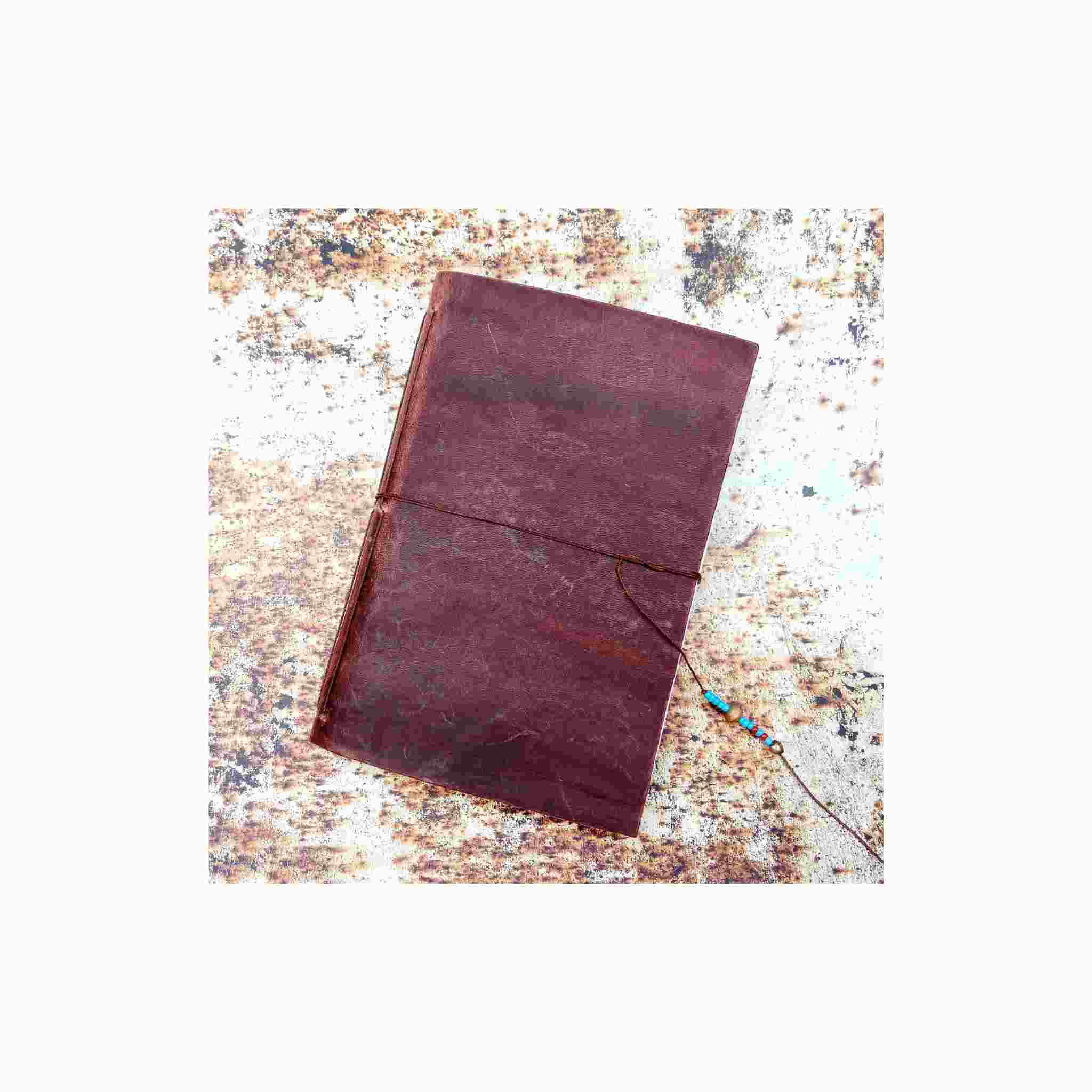 Leather notebook photographed on rust printed leather backdrop