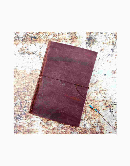 Leather notebook photographed on rust printed leather backdrop