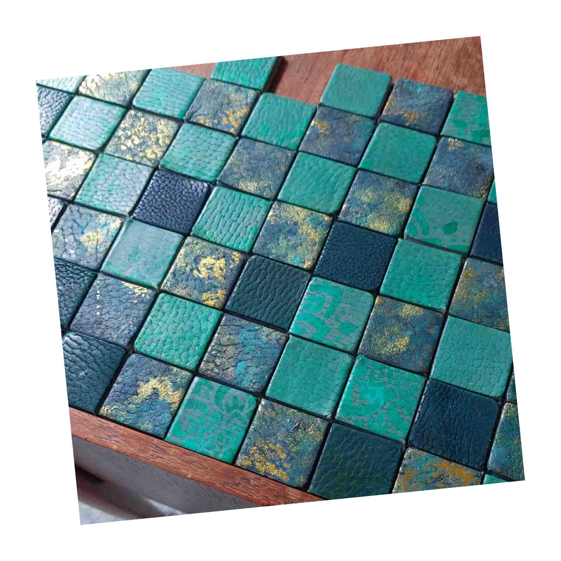 Planning out a leather tile mosaic for a table top, tiles painted, dyed and foiled