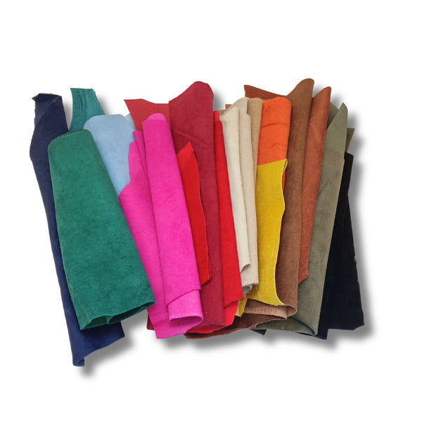 A bag of coloured soft suede leather pieces, hand sized or larger, some narrow and long.