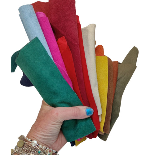 Load and play video in Gallery viewer, A bag of coloured soft suede leather pieces, hand sized or larger, some narrow and long.
