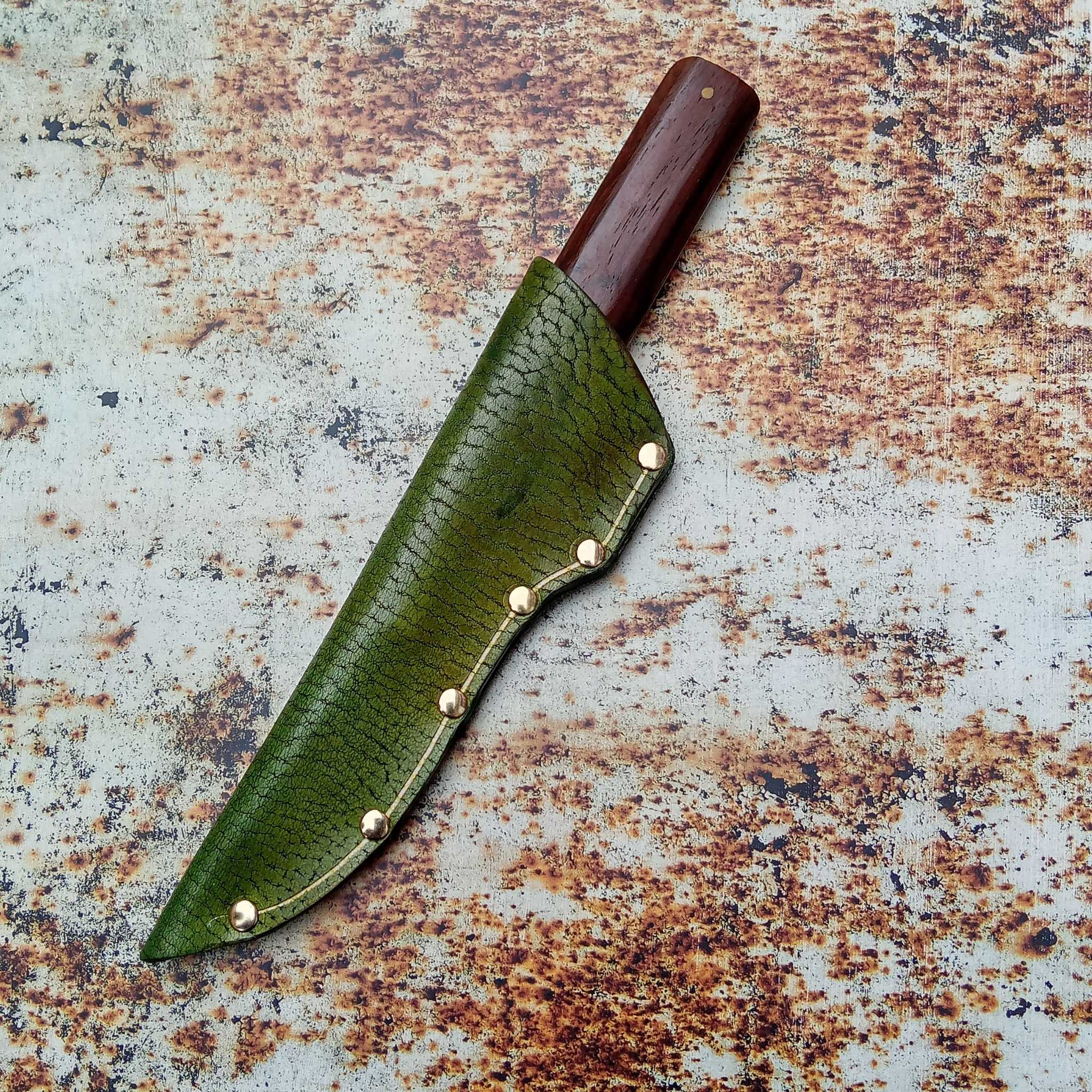 Showing a leather knife sheath on an A3 printed leather rust effect backdrop