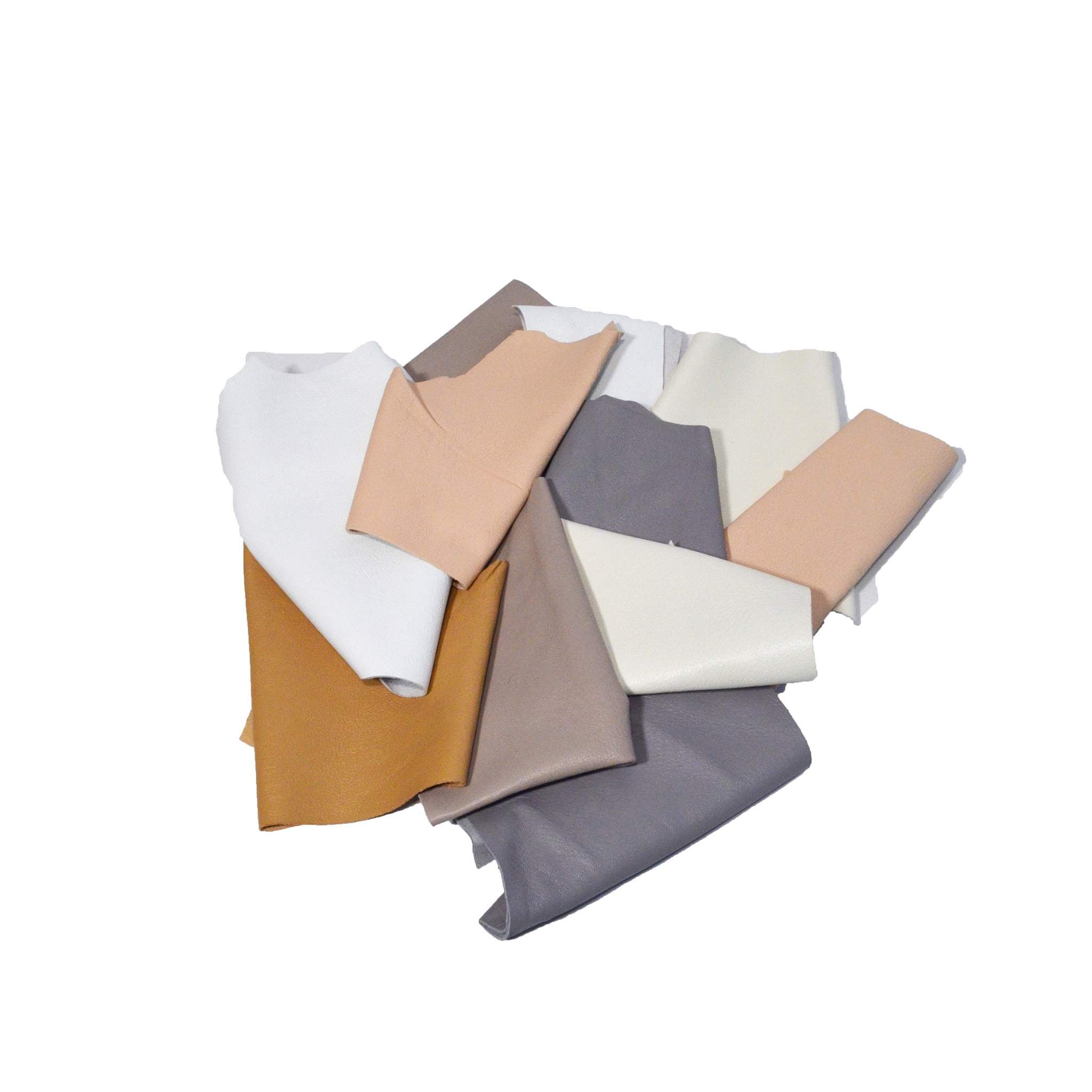 A bag of soft sheepskin leather pieces in neutral shades - whites, beiges, nude, pale grey etc., hand sized or smaller, suitable for applique, patchwork, mixed media, jewelry and other crafts