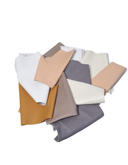 A bag of soft sheepskin leather pieces in neutral shades - whites, beiges, nude, pale grey etc., hand sized or smaller, suitable for applique, patchwork, mixed media, jewelry and other crafts