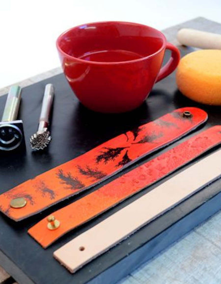 decorating veg tanned leather wristbands with ink stamps and embossing