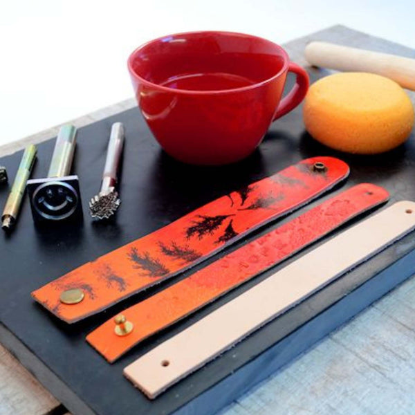 decorating veg tanned leather wristbands with ink stamps and embossing